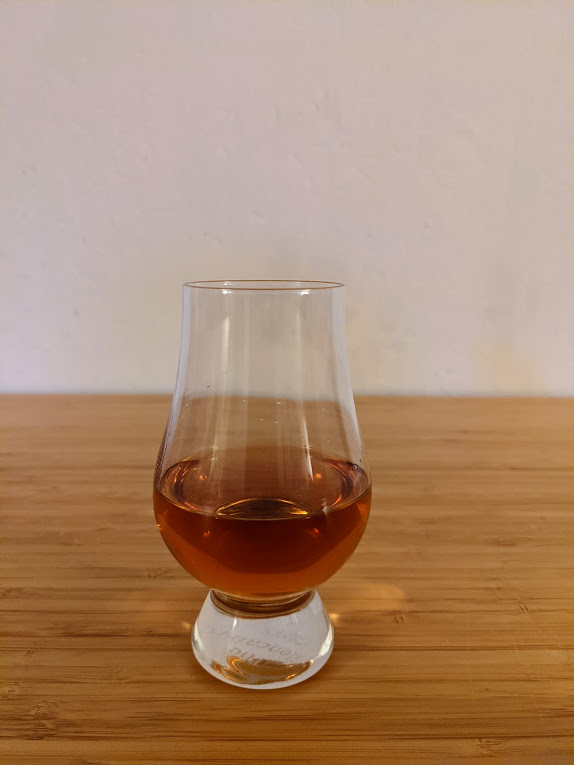 Rittenhouse Bottled-In-Bond dark brown liquid in a glencairn glass
