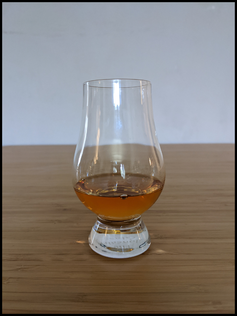 Evan Williams Bottled-In-Bond gold colored liquid in a glencairn glass