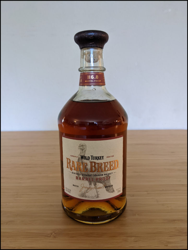 Bourbon bottle filled with carmel colored liquid with a a large turkey on the label.