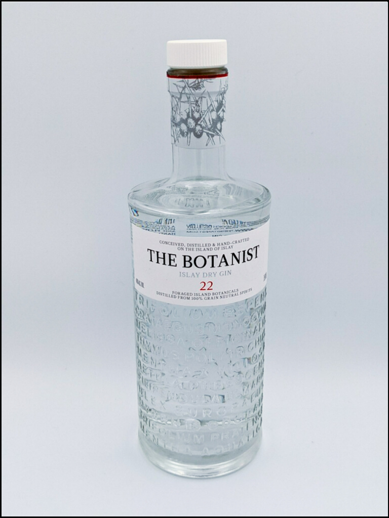 tall glass bottle with letters embossed on the lower half with white label with black and red colored writing