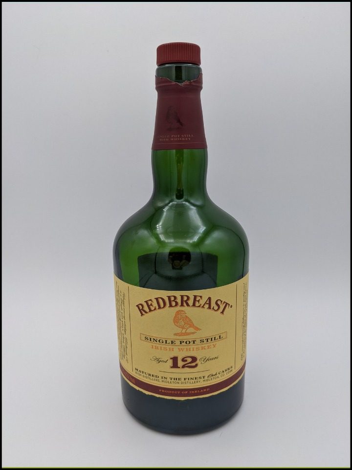 green bottle with a long neck with at a tan colored label with maroon colored lettering