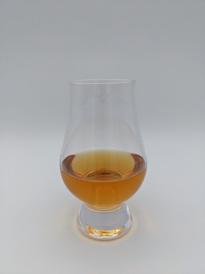 gold colored liquid in a glencairn glass