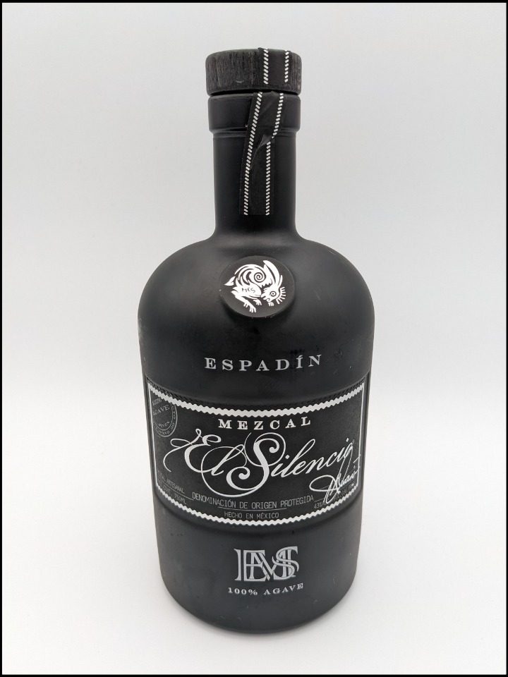 Black bottle with white label and lettering