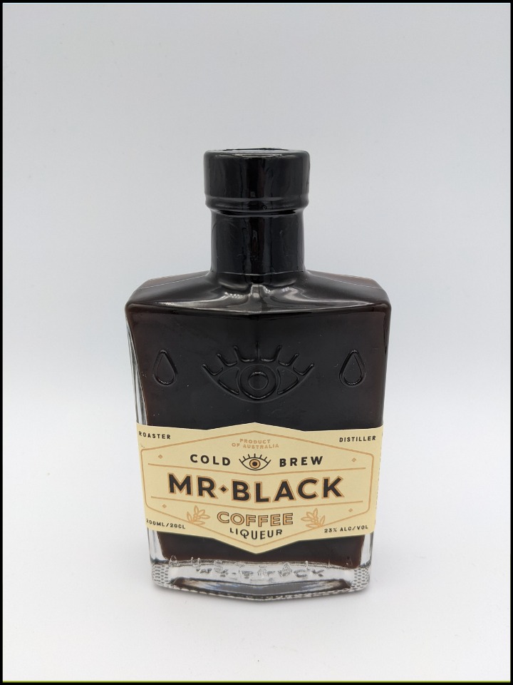 Black bottle with cream colored label with black lettering