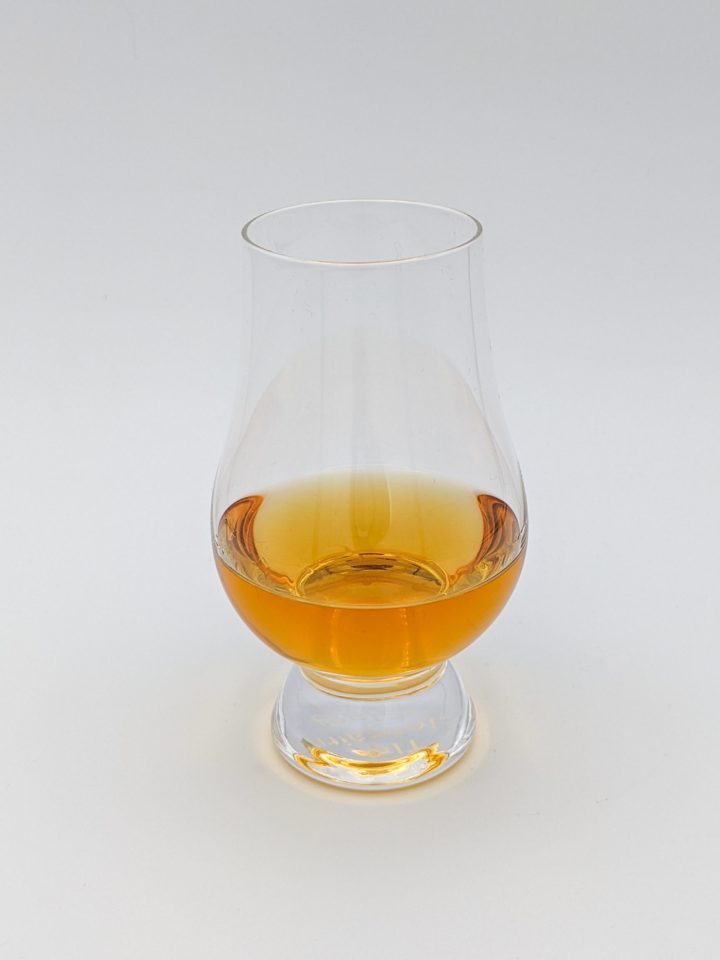 orange and gold liquid in a glencairn glass