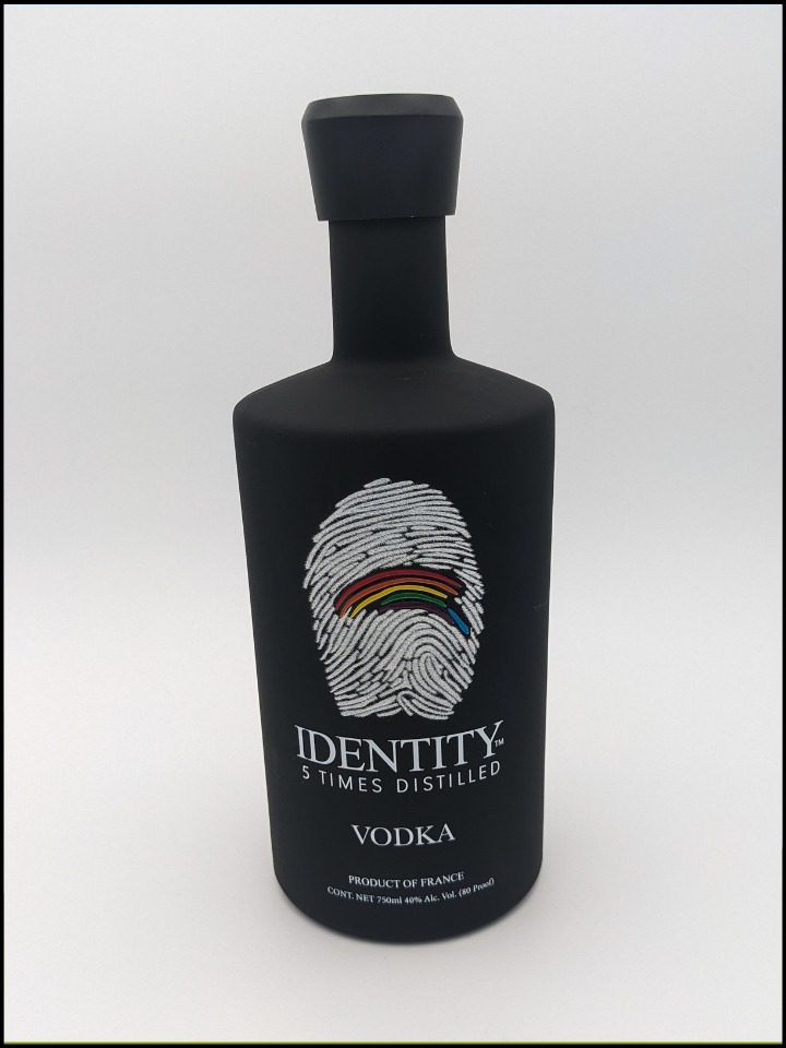 Black bottle with white lettering and a large fingerprint with rainbow colors
