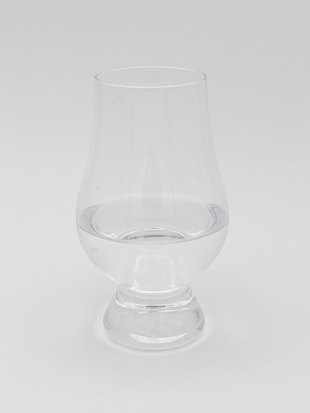 Clear liquid in a Glencairn glass