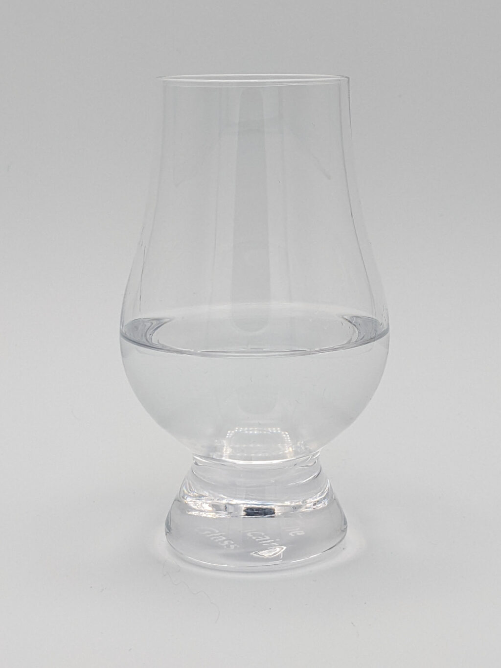 Clear liquid in a Glencairn glass