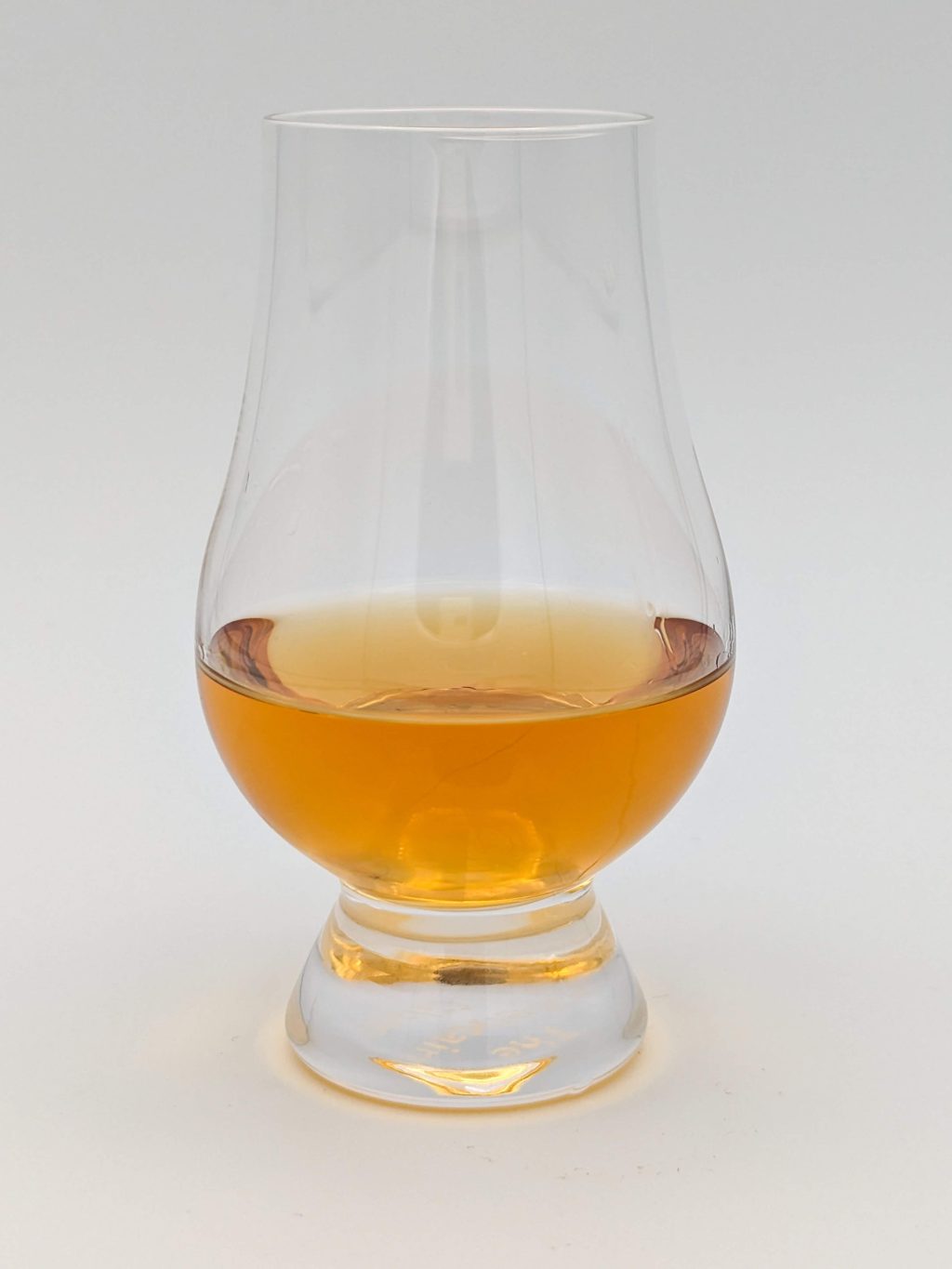 golden liquid in a glencairn glass