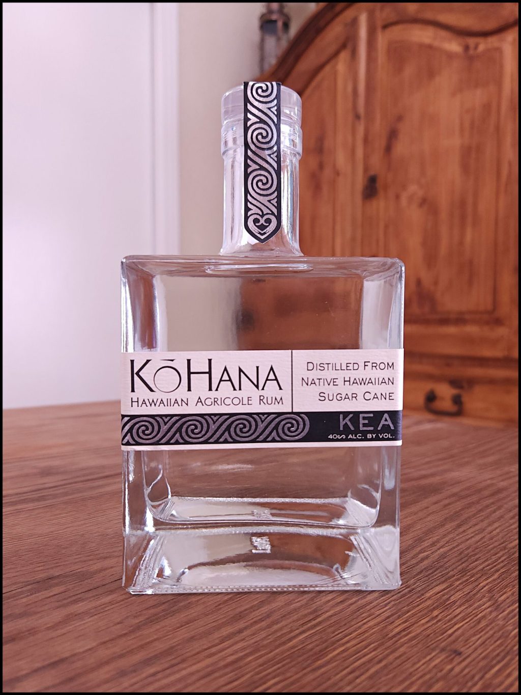 Bottle of Ko Hana Hawaiian Agricole Rum sitting on a wooden table