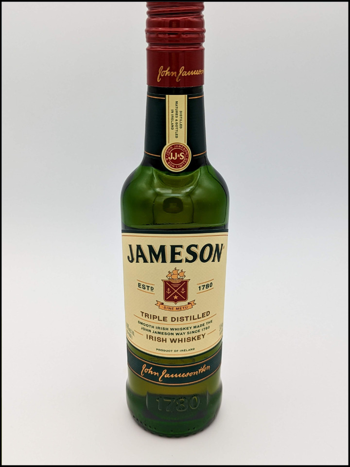 tall green bottle with cream colored label with green Jameson Irish Whiskey lettering