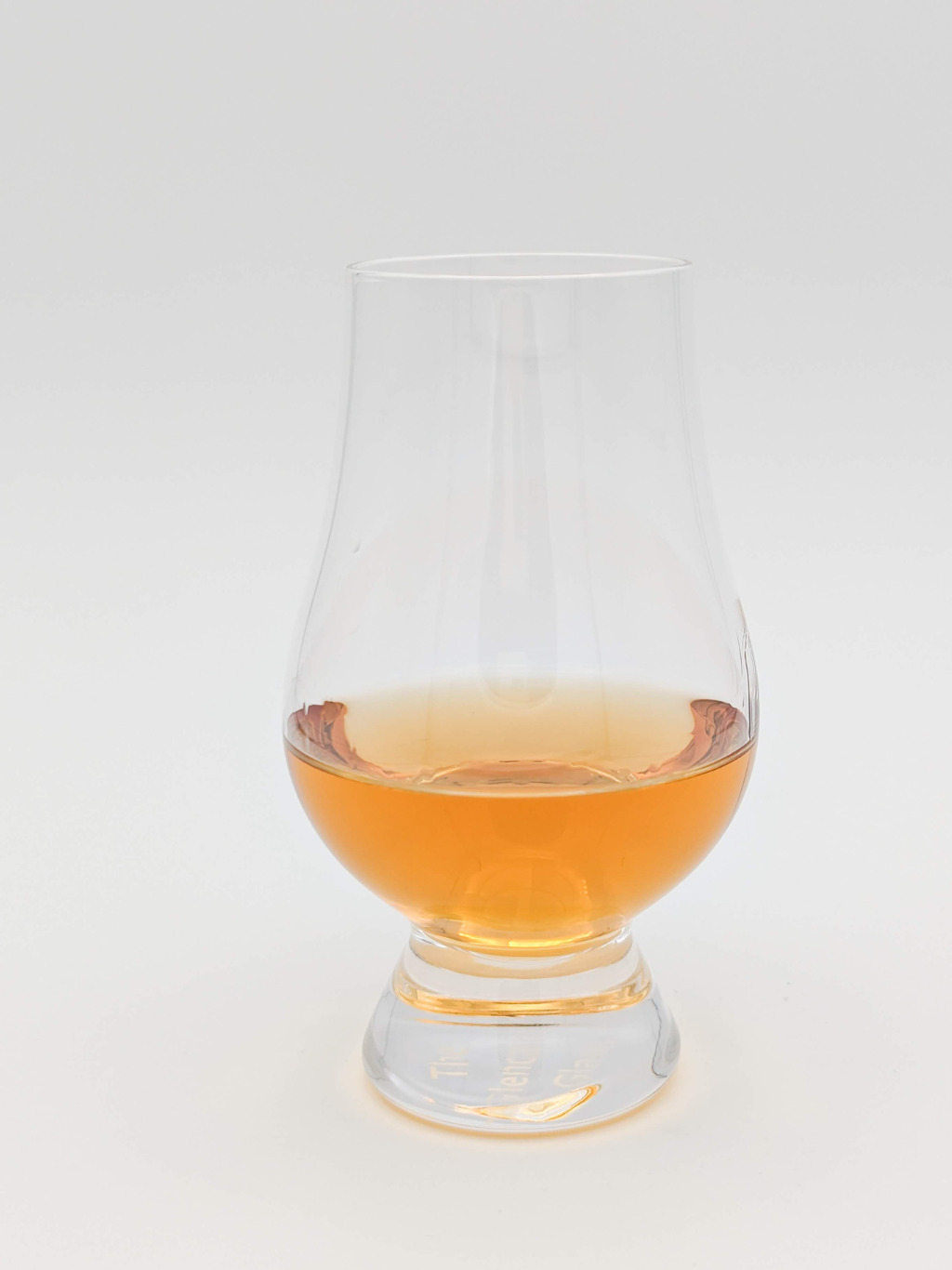 Honey colored liquid in a Glencairn glass