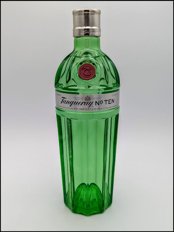 Tall green bottle with a silver label and top